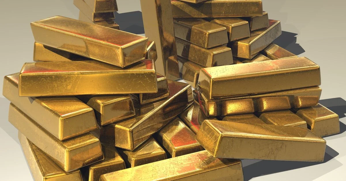 Une pile de lingots d'or brillants symbolisant la richesse et la prospérité.